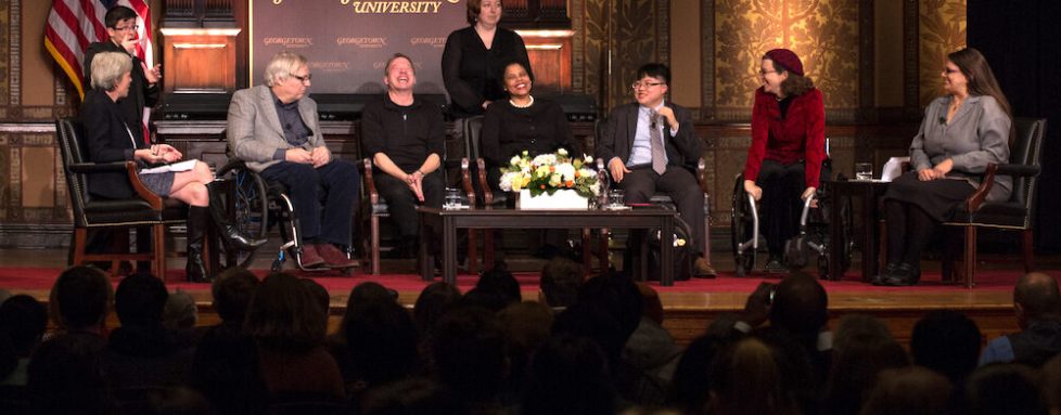 Lydia Brown and other advocates with disabilities speaking on a stage in front of an audience.